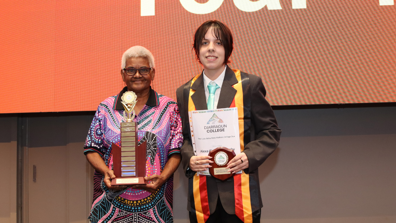 Two people receiving an award