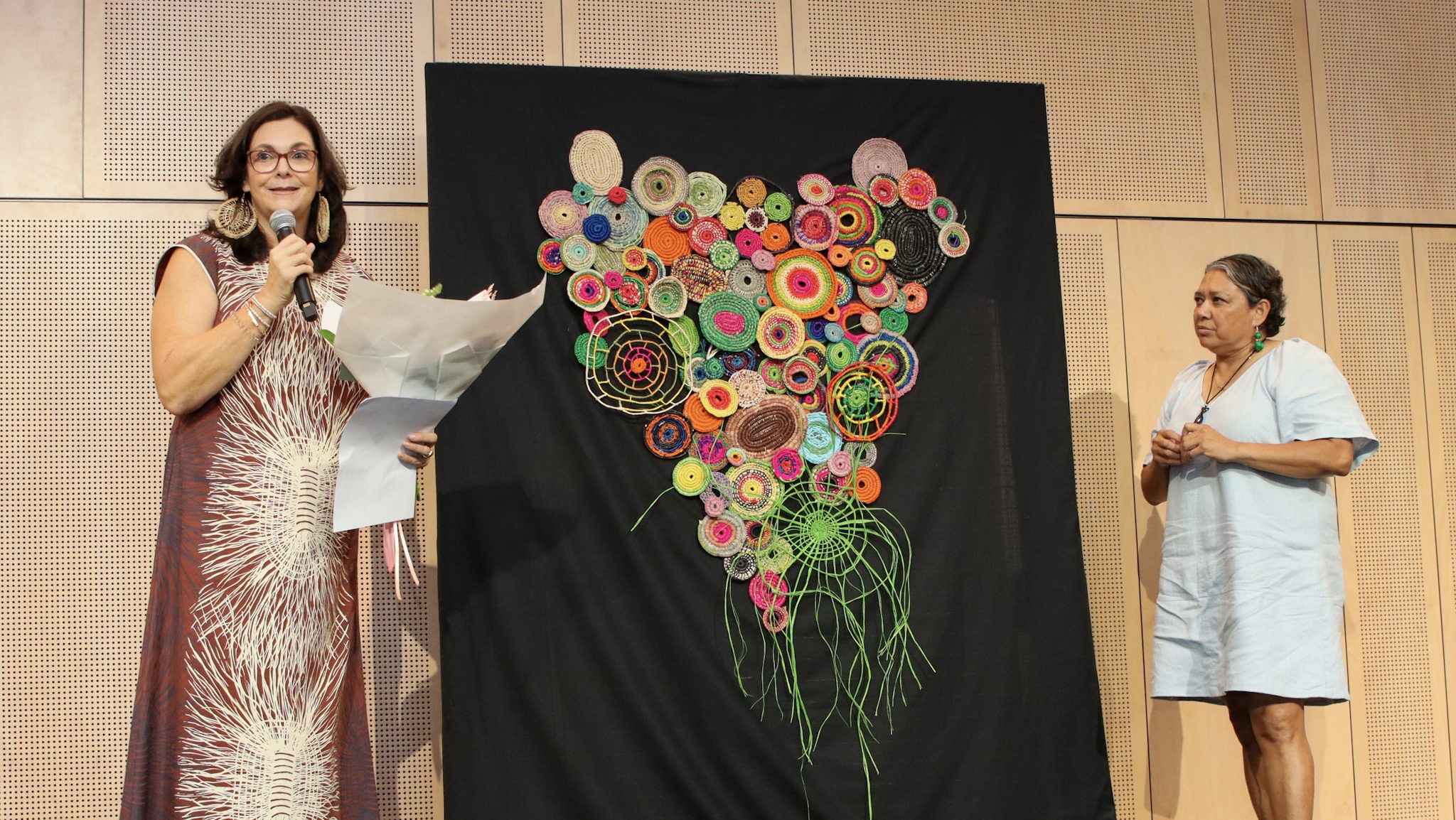 Cape York Partnership Managing Director Rose MAnzini handing a bouquet of flowers to Cape York Institute Leadership Academy Manager Floria King-Smith.