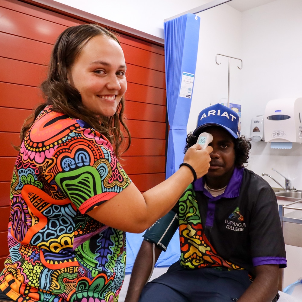 Xavier having his temperature taken as part of his health check.
