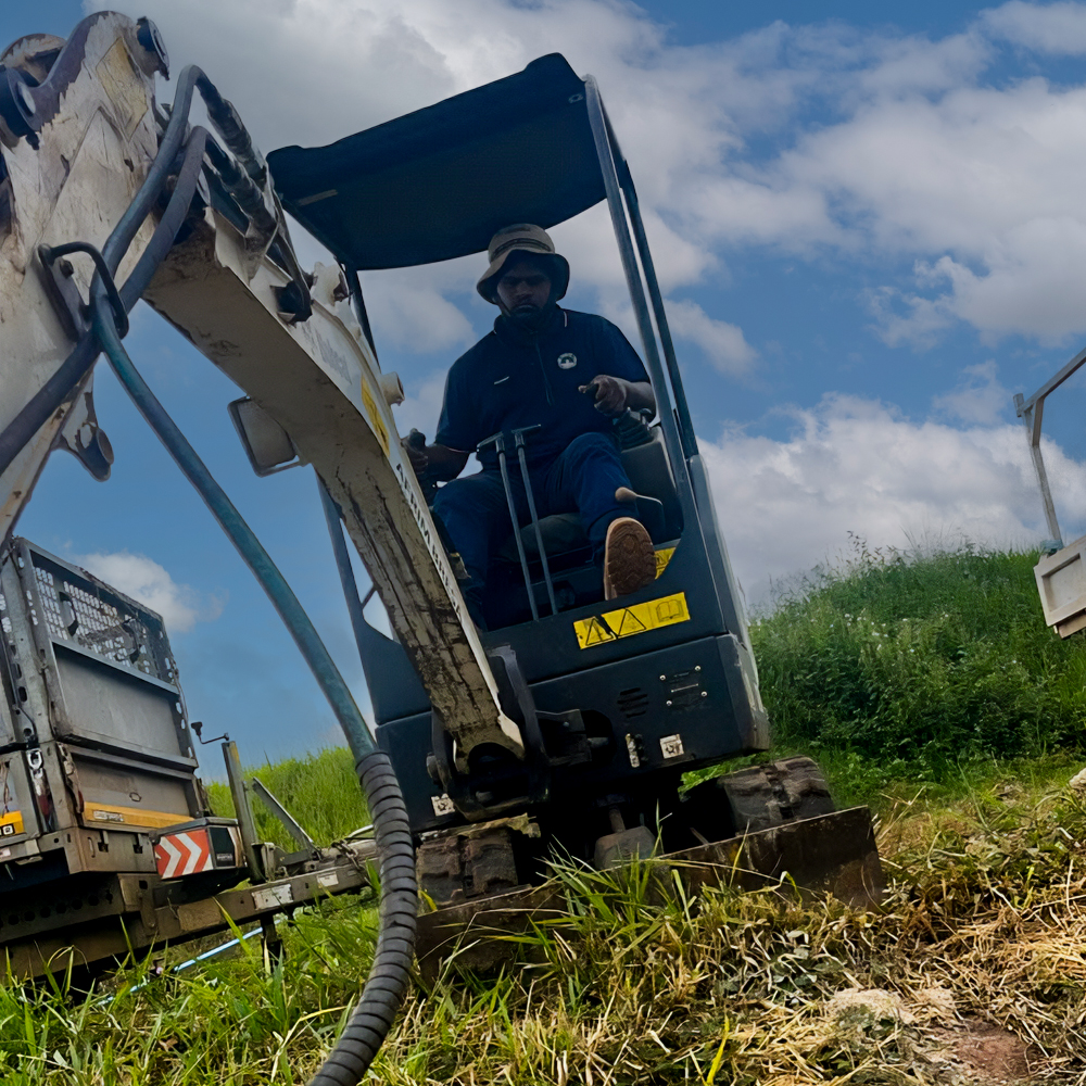 Meshech on an Excavator digging a trench